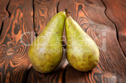 Two pears wooden on an background
