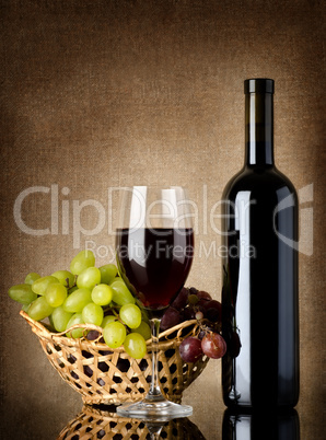 Wine and grapes on a old background