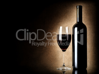 Wine bottle and wineglass on a old background