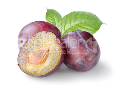 Three plums with leaves