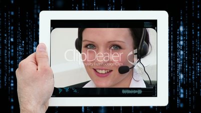 Hands using digital tablet displaying call centre workers