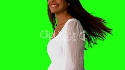 Girl in white dress twirling on green screen close up