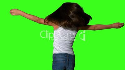 Little girl twirling on green screen