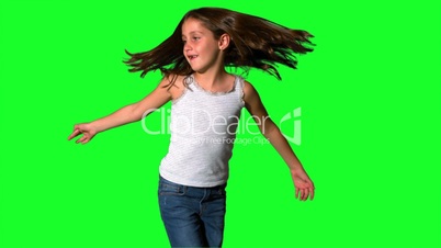 Little girl spinning around on green screen
