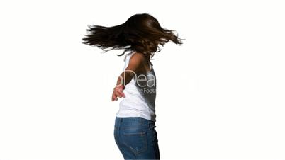 Little girl spinning around on white background