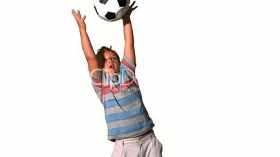 Boy catching football on white background