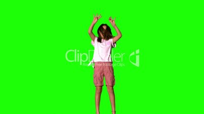 Girl jumping up on green screen