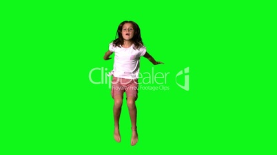 Happy girl jumping on green screen