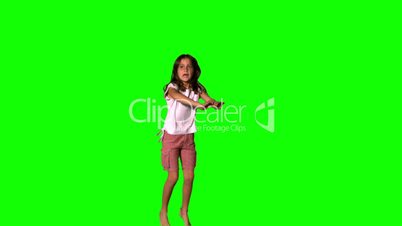 Happy girl jumping up on green screen