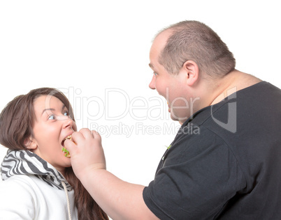 Fat Man Feeding a Girl a Burger