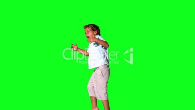 Little boy jumping and shouting on green screen