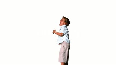 Little boy jumping and shouting on white background side view