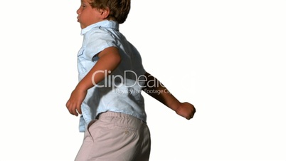 Little boy jumping and turning on white background