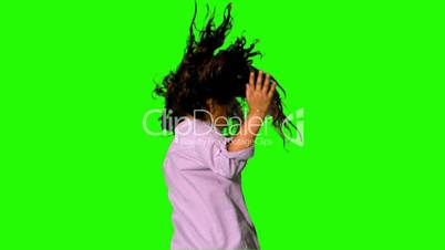 Little girl jumping and turning on green screen