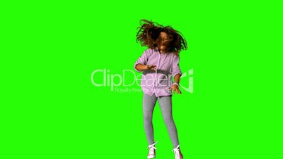 Happy little girl jumping on green screen