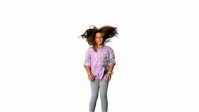 Happy little girl jumping up and down on white background