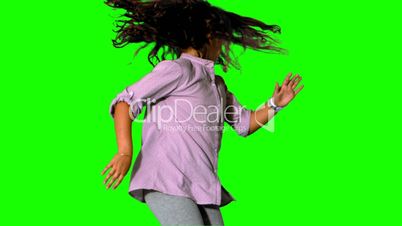 Girl jumping and spinning on green screen