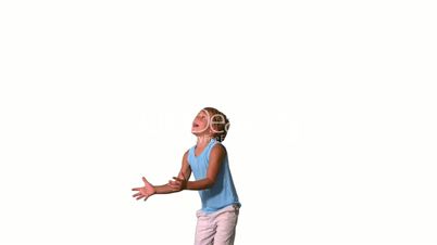 Boy jumping and catching teddy bear on white background