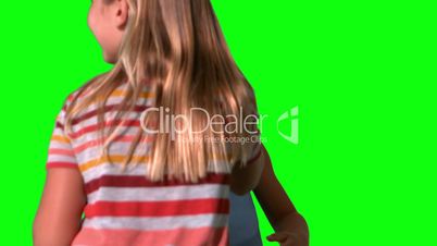 Siblings jumping together on green screen