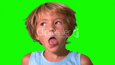 Little boy shaking head on green screen