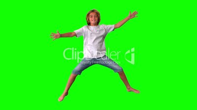 Boy jumping up and down on green screen