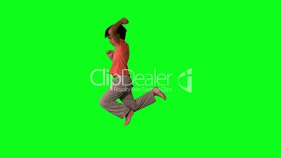 Side view of boy jumping on green screen