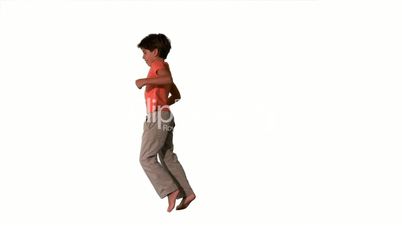 Side view of boy jumping up on white background