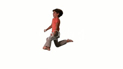 Side view of happy boy jumping up and down on white background