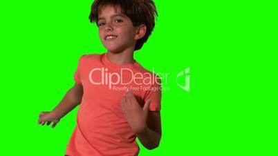 Close up of boy jumping on green screen