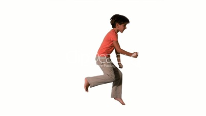 Boy jumping on white background side view