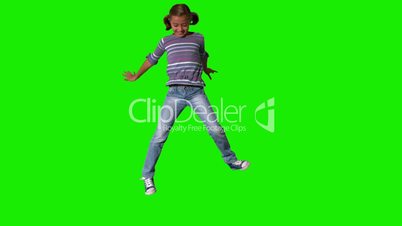 Smiling girl jumping up and down on green screen