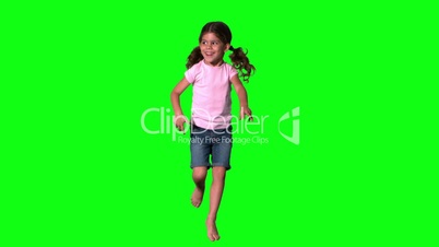 Cute little girl jumping on green screen
