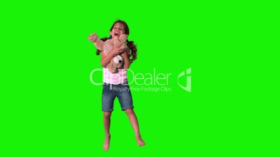 Cute little girl jumping and catching teddy on green screen