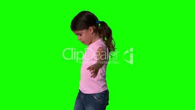 Cute little girl spinning around on green screen