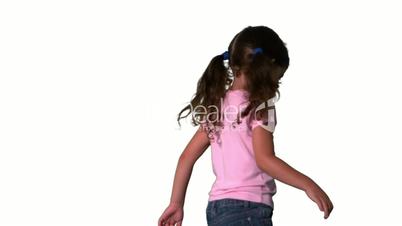 Cute little girl spinning around on white background