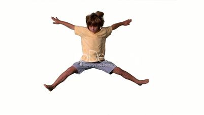 Little boy jumping with limbs outstretched on white background