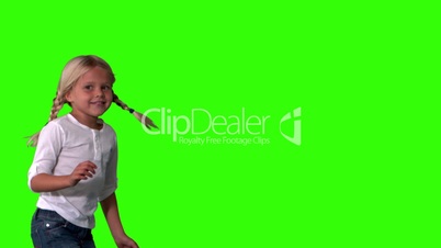 Cute girl in pigtails jumping on green screen