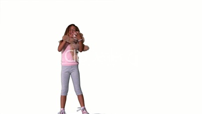 Little girl jumping and catching teddy on white background