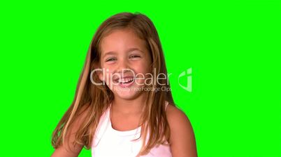 Close up of little girl laughing and turning on green screen