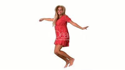 Attractive blonde jumping on white background