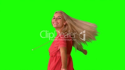 Attractive blonde twirling on green screen