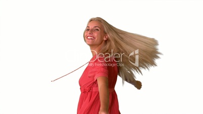 Attractive blonde twirling on white background