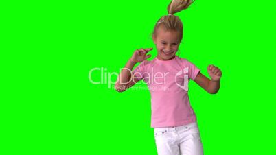 Joyful little girl jumping on green screen