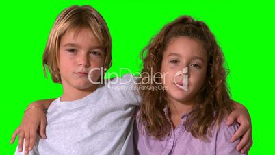 Siblings smiling on green screen