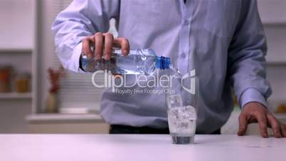 Man pouring water into a glass