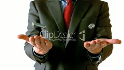 Man in suit tossing screw and bolt
