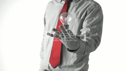 Man in shirt and tie tossing a light bulb