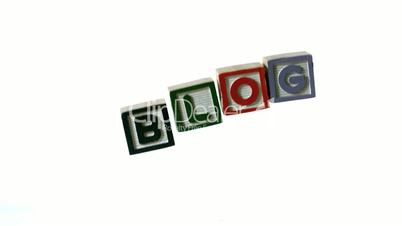 Row of blocks spelling Blog falling over