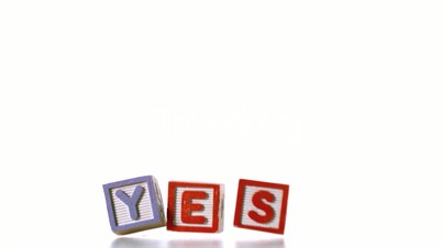 Yes spelled out in letter blocks falling over
