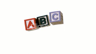 Row of blocks spelling abc falling over